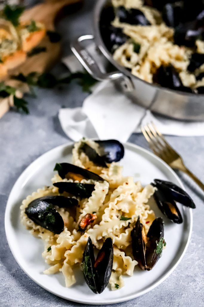 Pasta on white plate with mussels