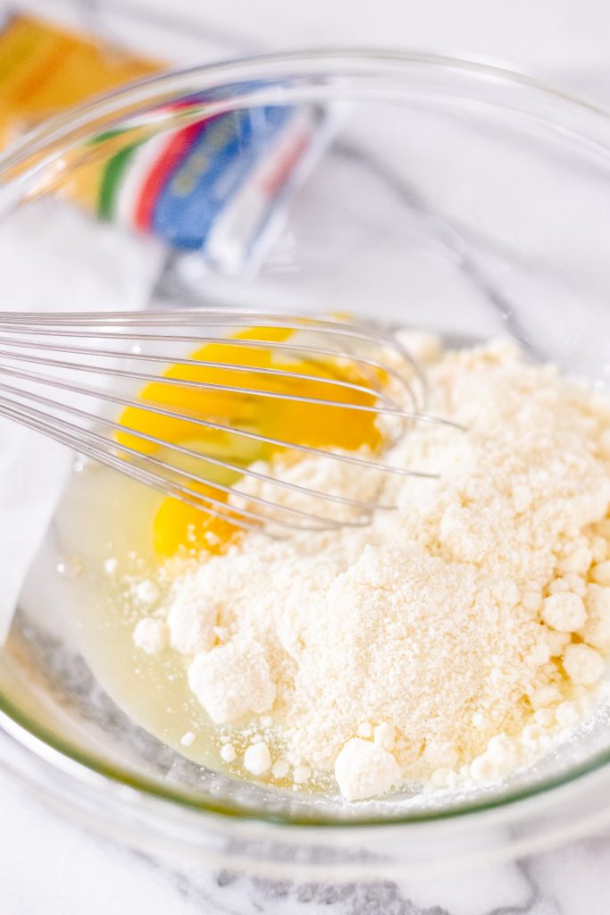 How to make spaghetti carbonara: whisk eggs and pecorino romano cheese together