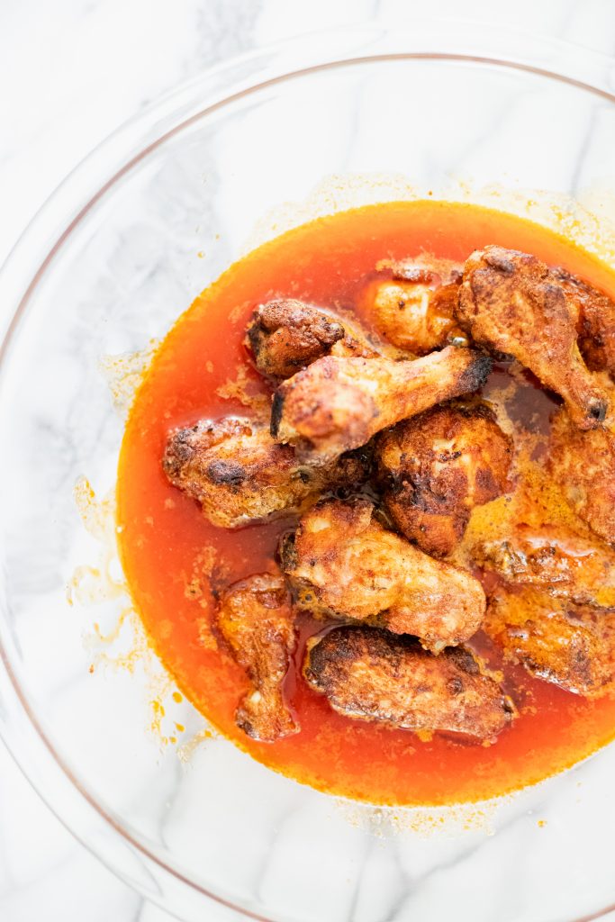 Wings in a bowl of hot sauce