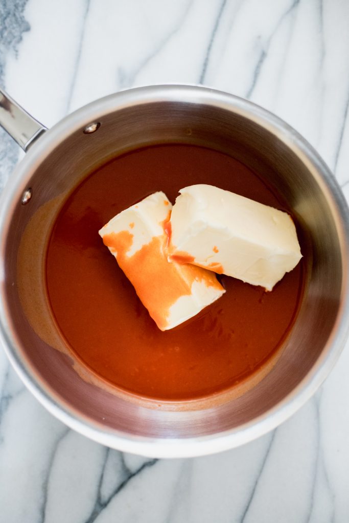 Cold sticks of butter in hot sauce placed in a saucepan