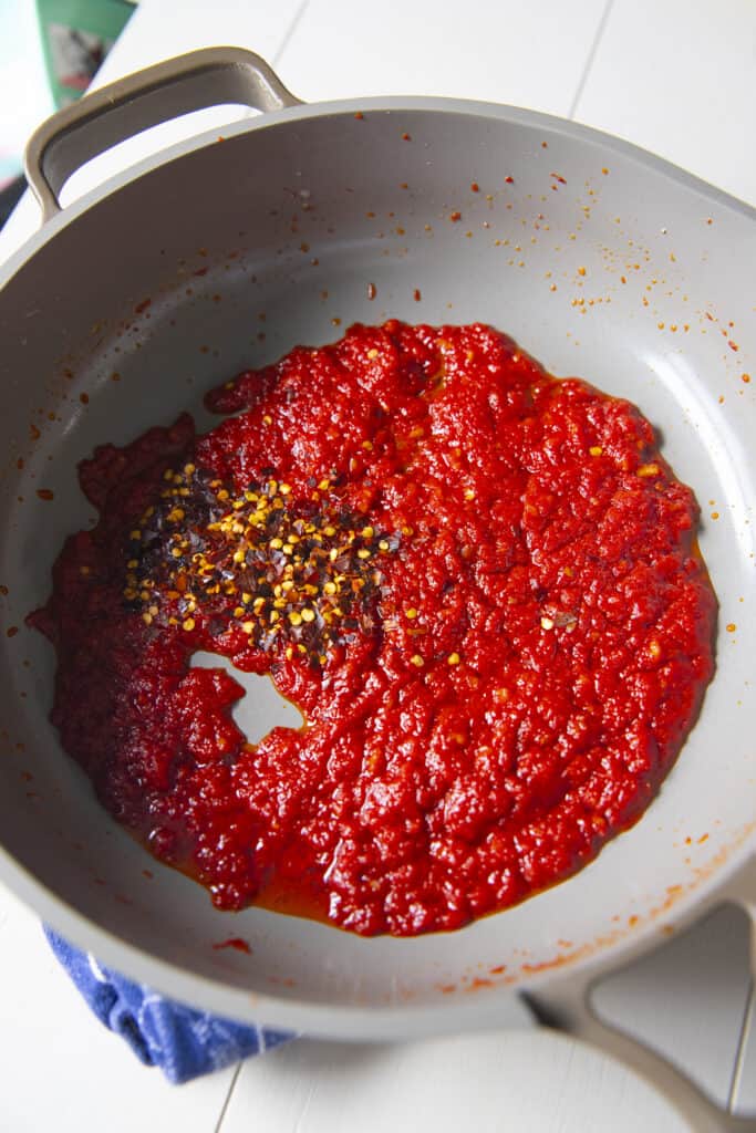 Red sauce with red pepper flakes in a pan