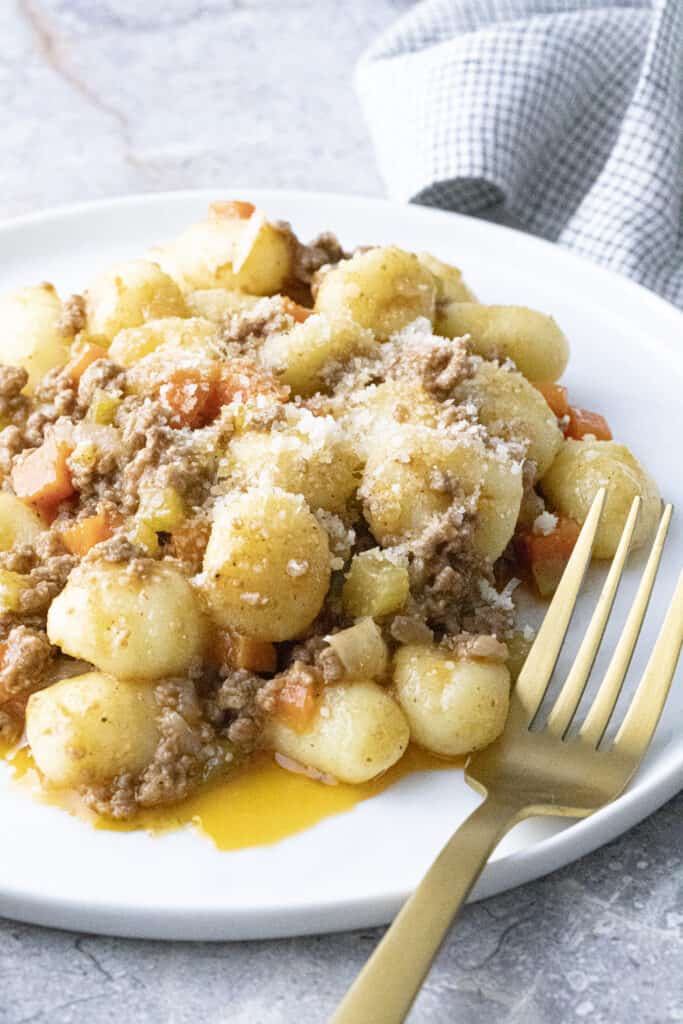 Gnocchi Bolognese on a white plate