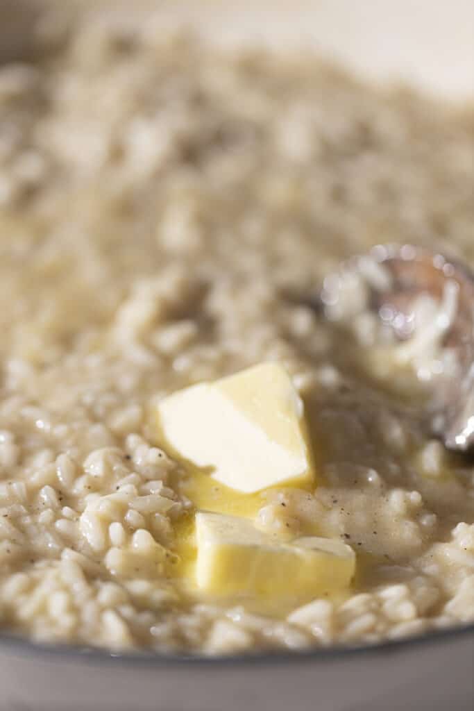 Butter melting in cooked risotto.