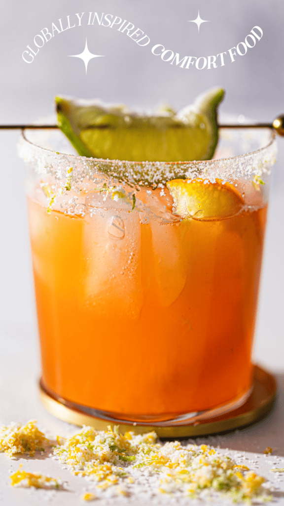 Photo of an orange margarita with the phrase "globally-inspired comfort food"