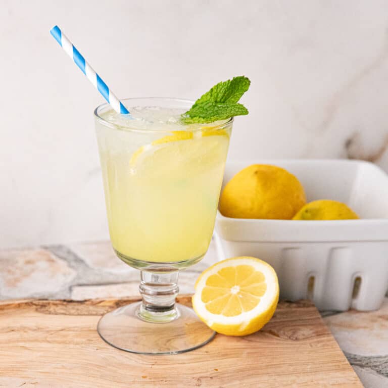 A limoncello spritz in a glass with a straw.