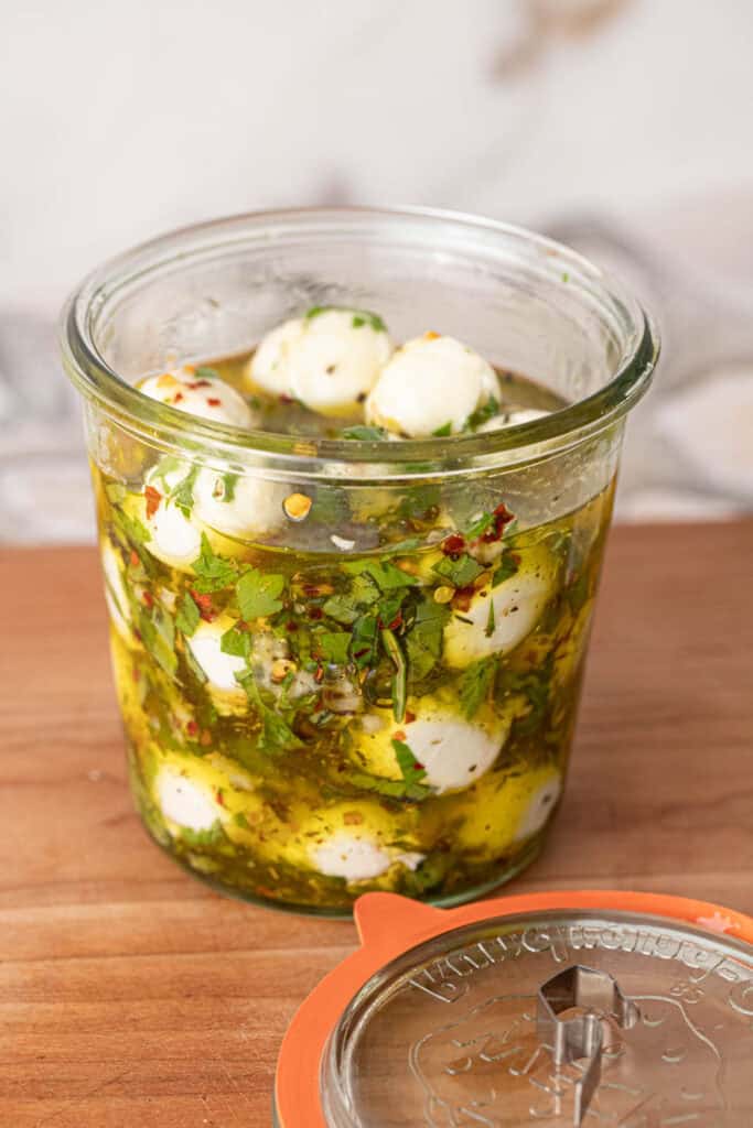 Marinated mozzarella balls recipe in a glass jar.