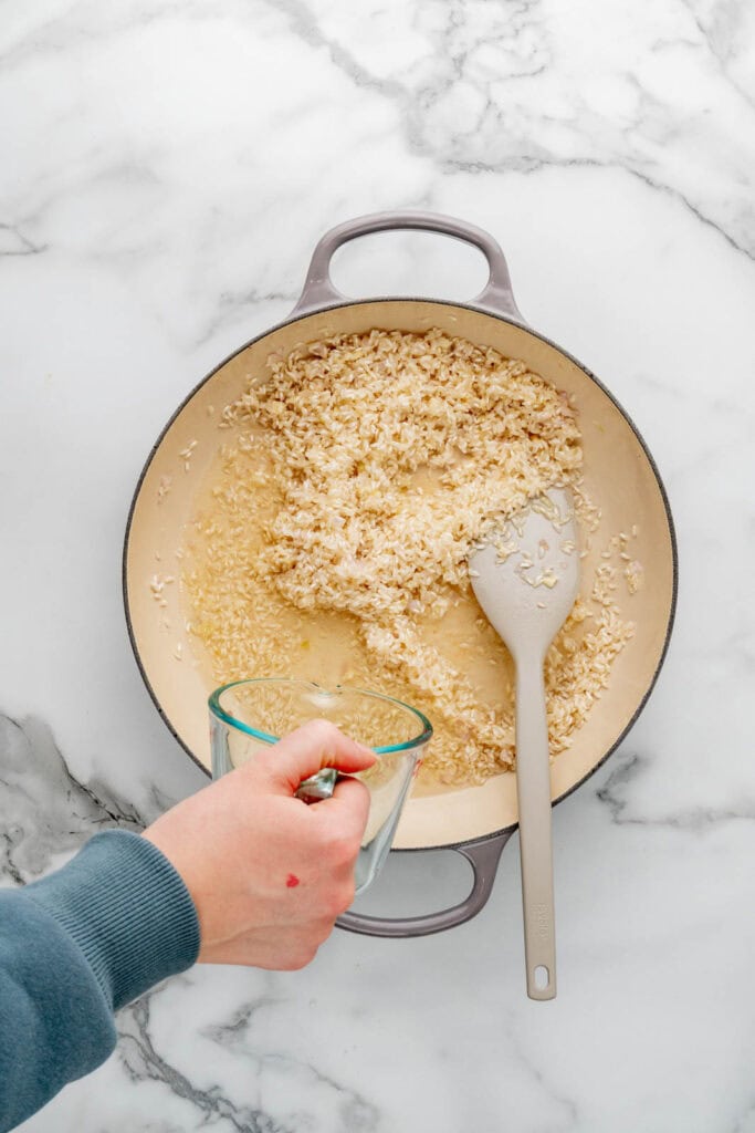 Cooking artichoke risotto.