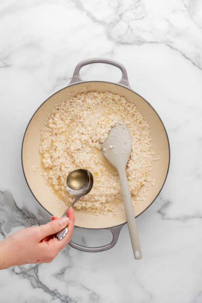 Cooking artichoke risotto.
