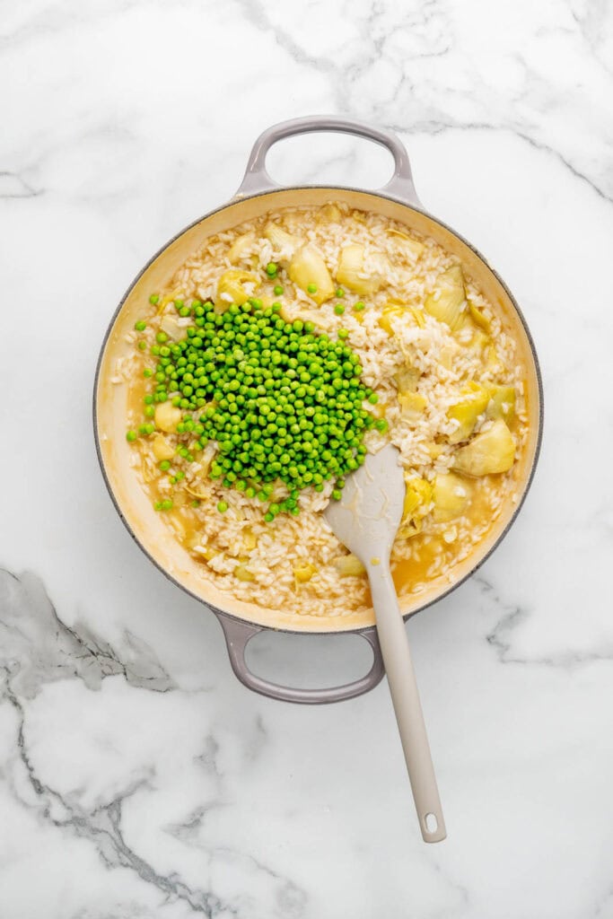 Cooking artichoke risotto.