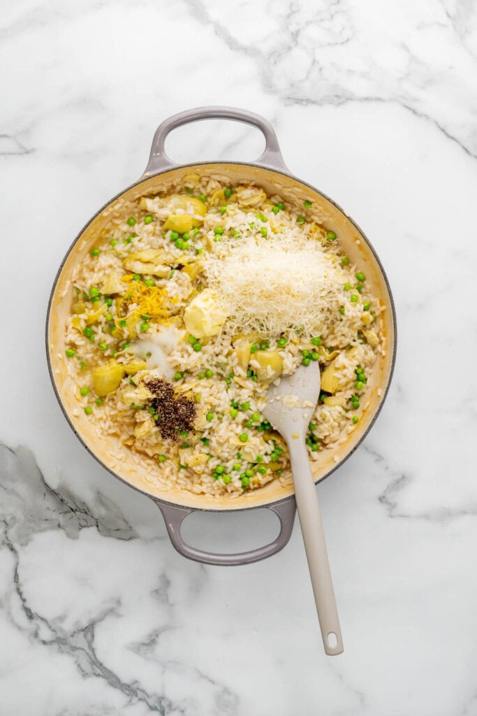 Cooking artichoke risotto.