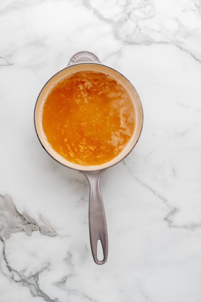 Warming chicken stock for an easy pastina recipe.
