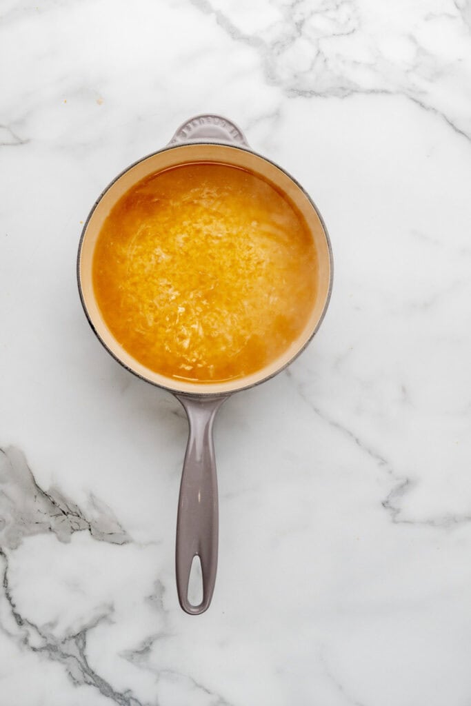 Cooking pasta in chicken stock for an easy pastina recipe.
