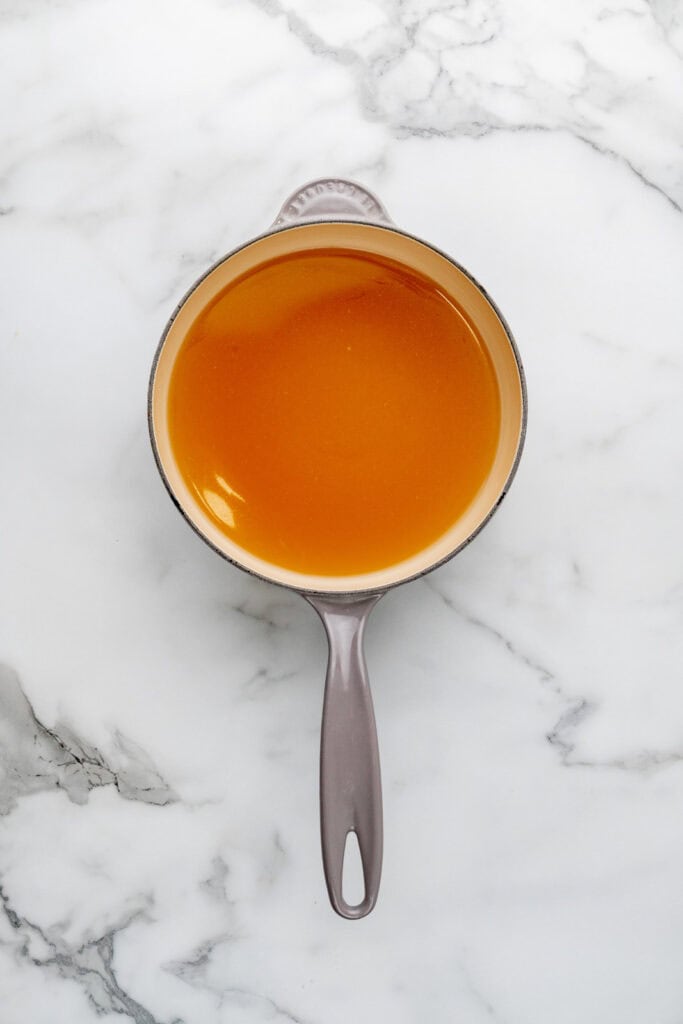 Warming stock to make risotto al limone.