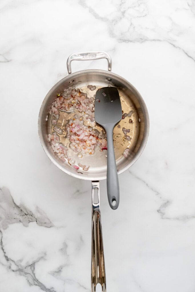 Sauteing aromatics to make the base of a tomato pastina recipe.