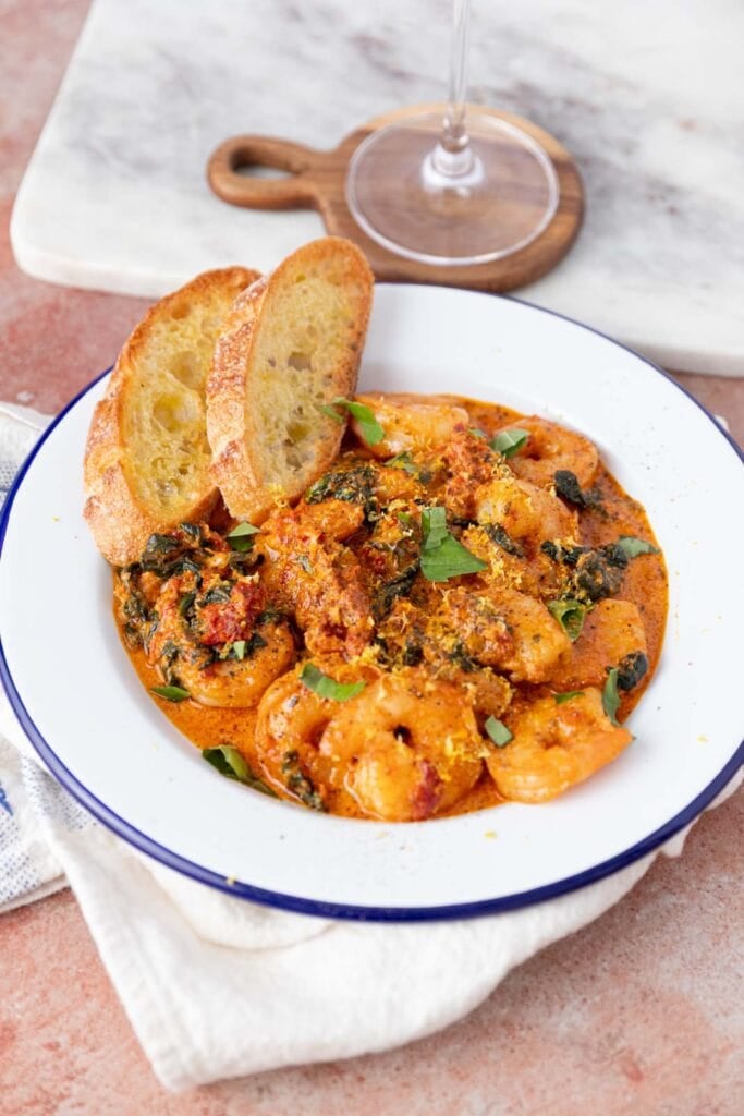 Creamy tuscan shrimp in a bowl.
