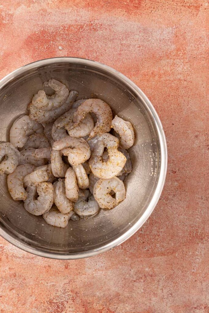 Seasoning shrimp in a bowl.