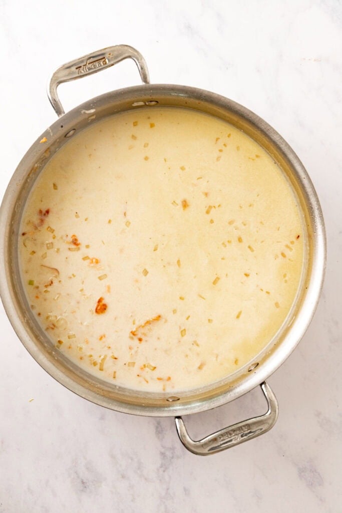 Rice in coconut milk cooking in a pot.