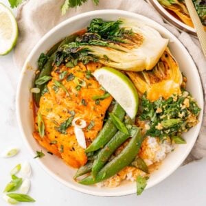 Salmon with coconut curry and rice in a bowl.