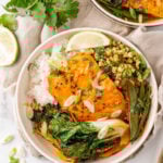 Salmon with coconut curry and rice in a bowl.