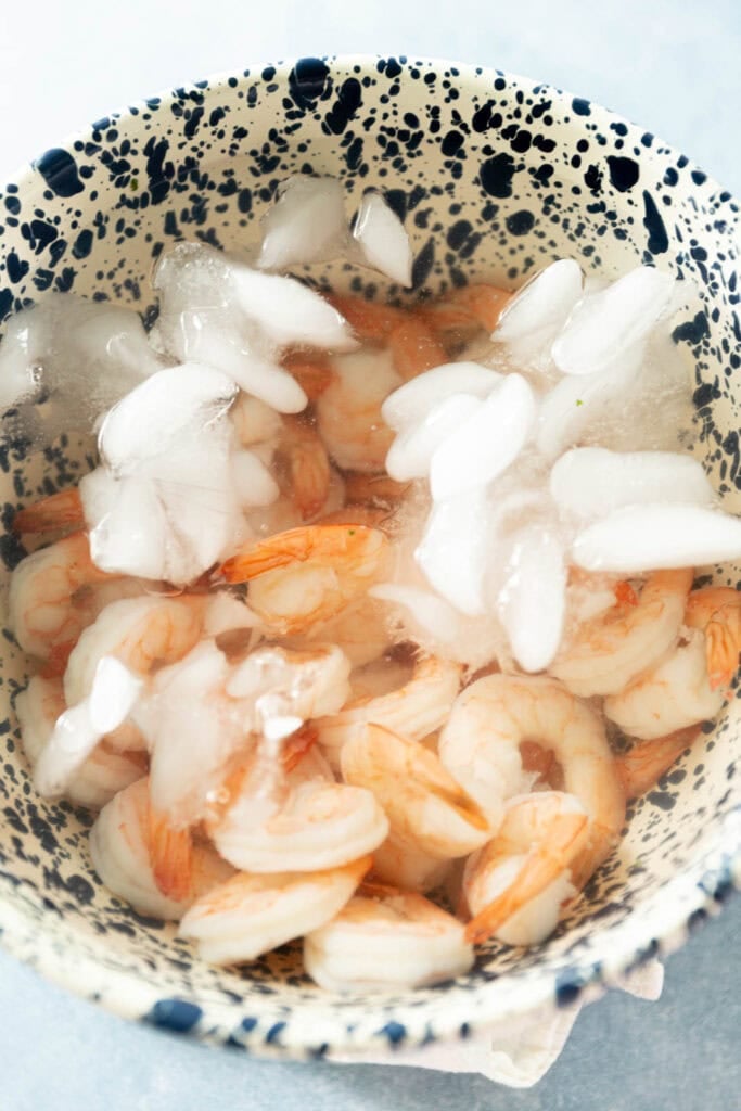 Poached shrimp in an ice bath.