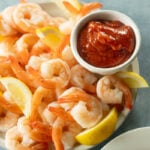 Shrimp Cocktail with lemon and cocktail sauce.