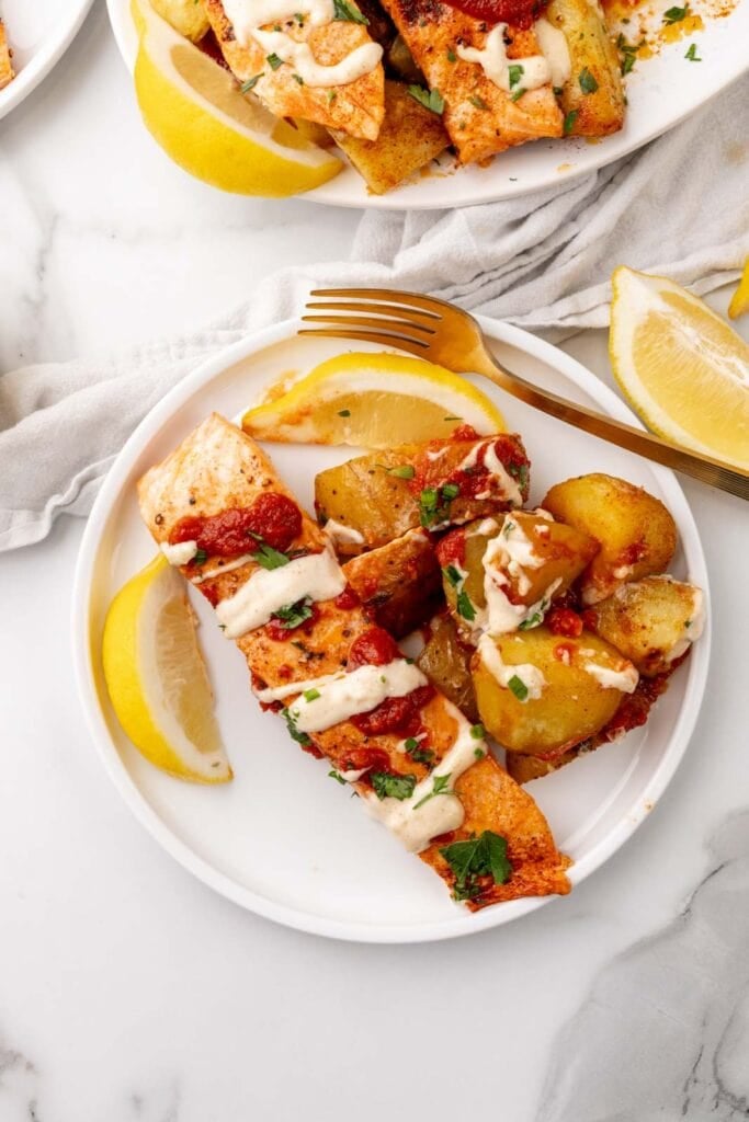 Salmon with potatoes on a plate.