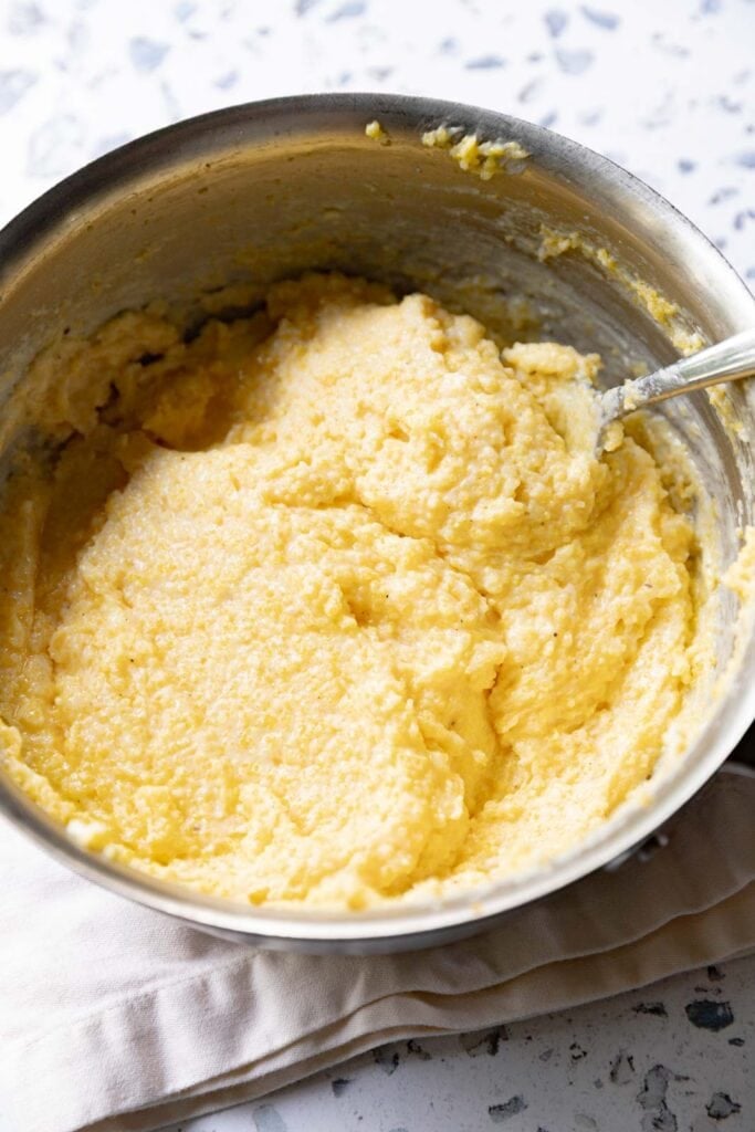 Creamy, cheesy polenta in a pan.