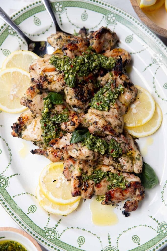 Grilled chicken thighs with chimichurri sauce.