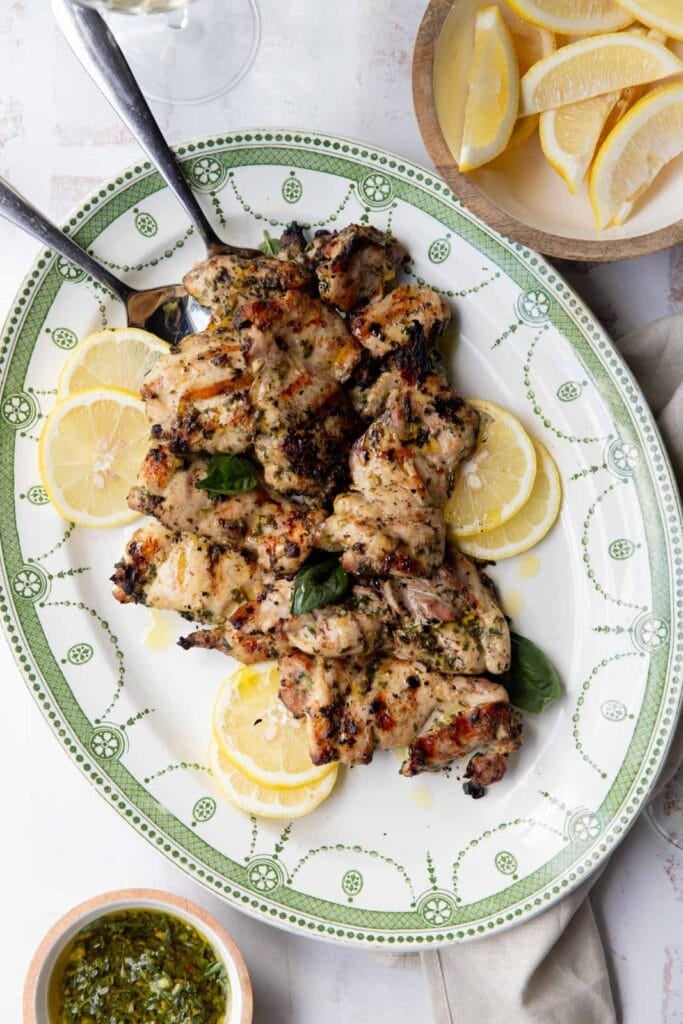 Grilled chicken thighs with chimichurri sauce.