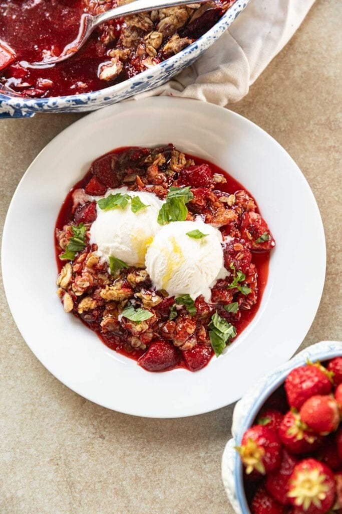 A strawberry crumble with vanilla ice cream, basil.