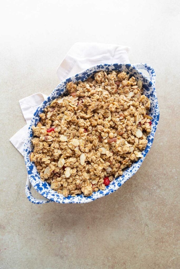 A strawberry crumble unbaked in a baking dish.