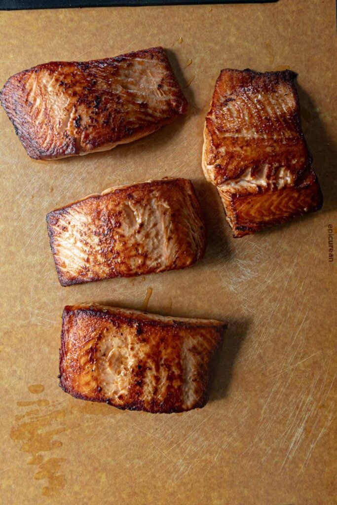 Seared salmon on a cutting board.