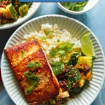 Asian style salmon and cucumber salad with rice in a bowl with chili crisp.